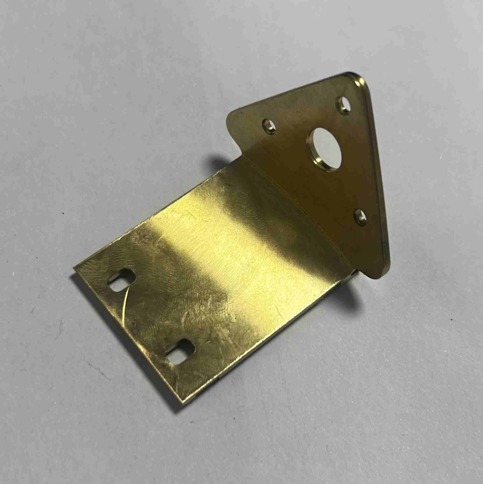 Custom copper fixture or mount with 3D geometry, showcasing multi-axis machining capability for specialized applications.