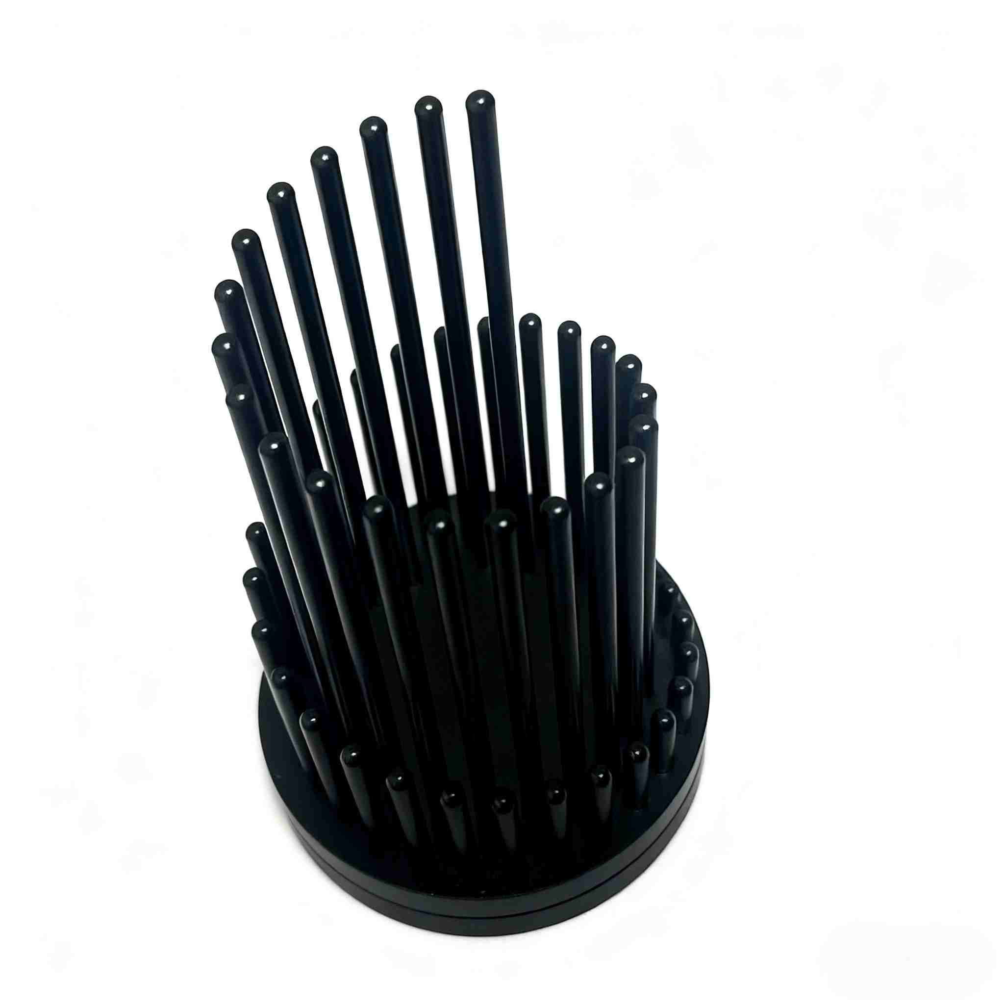 Modern cylindrical pen holder made from CNC-machined aluminum with vertical pillar design and matte black anodized finish.