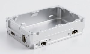 Precision CNC machined aluminum end cover for an electric motor, with critical bearing bore and connector hole tolerances.
