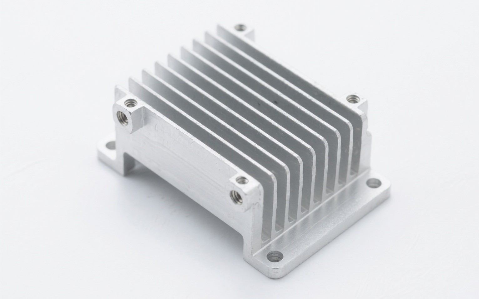 Aluminum heatsink enclosure for an electronic control unit (ECU), integrating cooling fins and mounting features in one part.