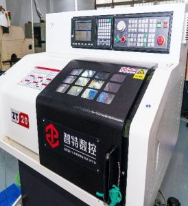Vertical Machining Center (VMC) milling a solid steel block for industrial machinery components.