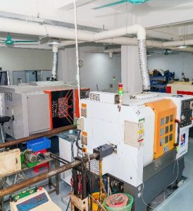 Swiss-type CNC lathe (Sliding Headstock) for machining long, slender components with micron-level accuracy.