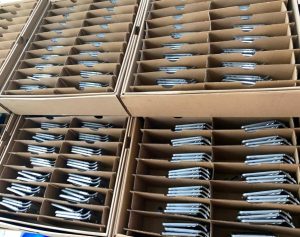Close-up of a precision CNC part being carefully wrapped in protective packaging to prevent any damage during transit.