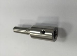 Stainless steel connector component for electrical or fluid systems, showcasing precision CNC milling and turning.