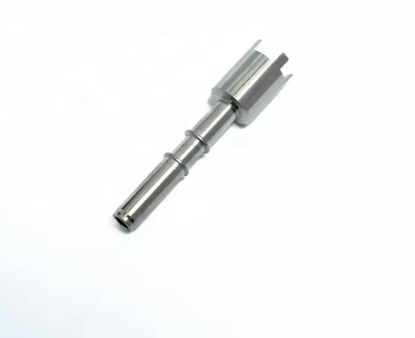 Thin-walled hypodermic tube component, demonstrating the Swiss lathe's ability with delicate parts.