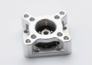 Lightweight UAV motor mount, CNC machined from aluminum with strategic weight reduction pockets, maintaining high stiffness and precise arm alignment.