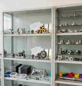 close-up-labeled-sample-storage Wall of successfully delivered CNC machined parts in our sample library, demonstrating our wide range of projects and materials.