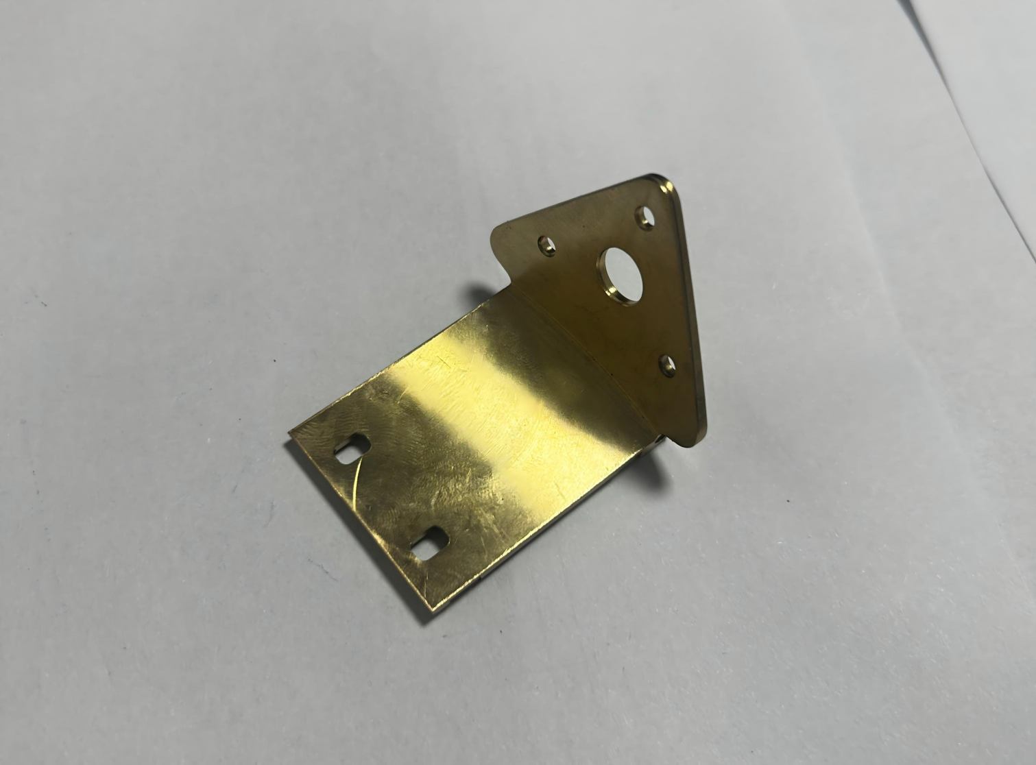CNC machined brass triangular automotive mounting bracket, custom precision metal car support plate, brass auto accessory with mounting holes