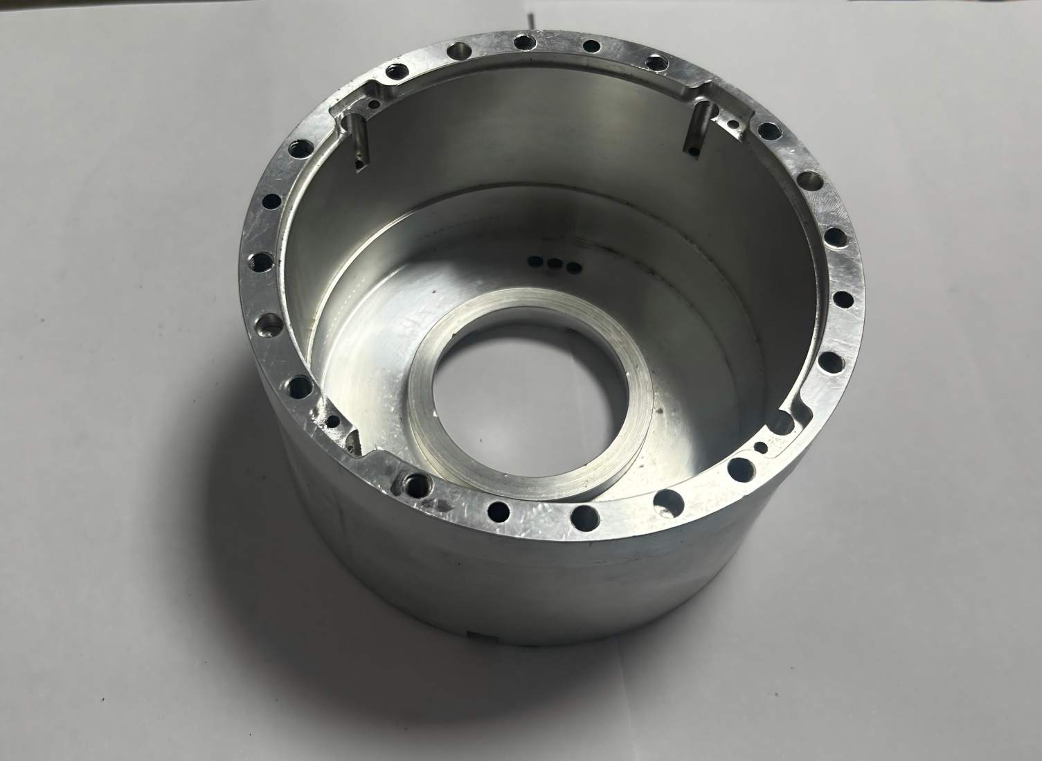 Precision CNC machined aluminum circular housing with mounting holes, custom aluminum flange base for industrial equipment, high-precision metal component for machinery