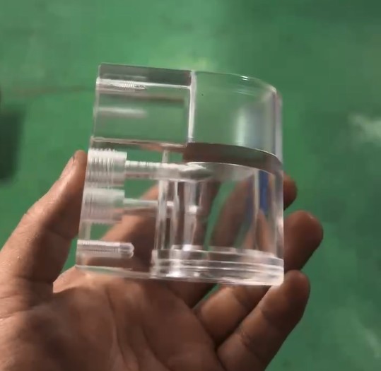 High-precision CNC machined transparent acrylic valve body, clear plastic fluid chamber for industrial equipment, custom acrylic component with internal channels